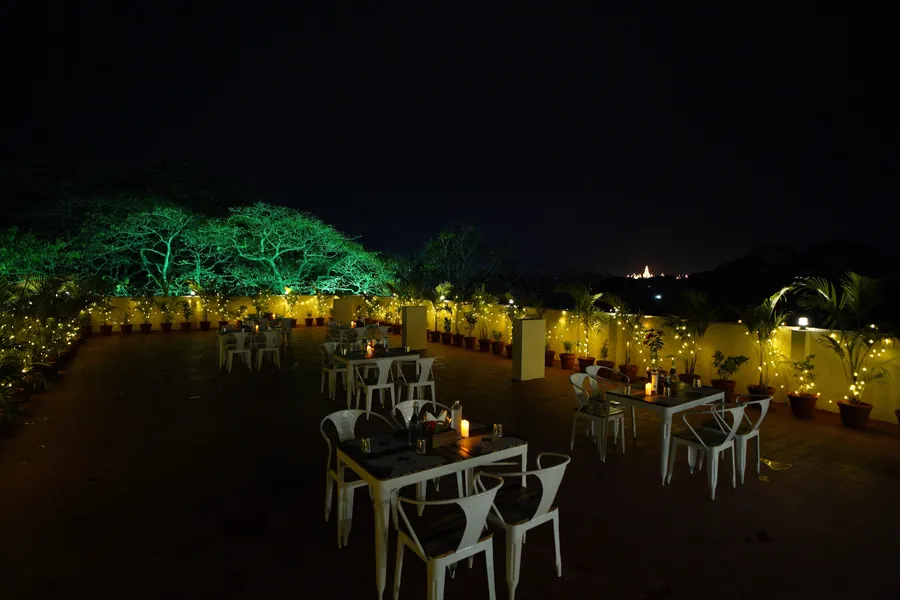 Open-air rooftop terrace lit up at night